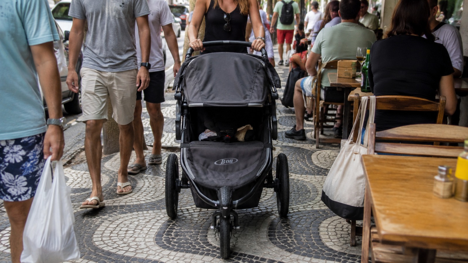 Wide three-wheel jogging stroller too large for the narrow Ipanema sidewalk in Rio de Janeiro