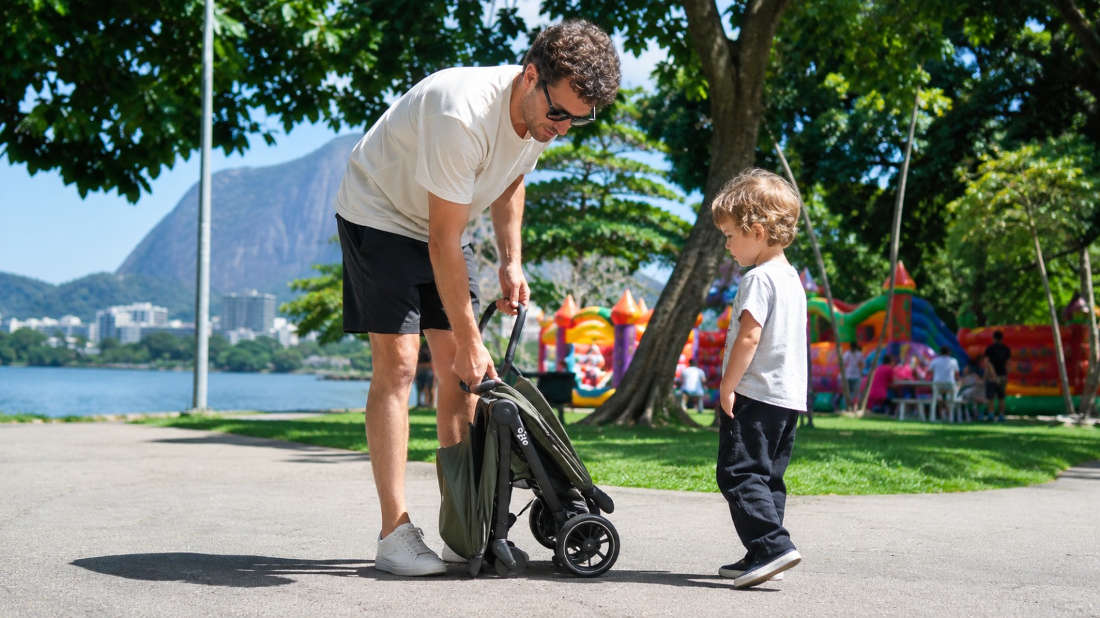 Father folding compact baby stroller one-handed on the Ipanema sidewalk in Rio de Janeiro